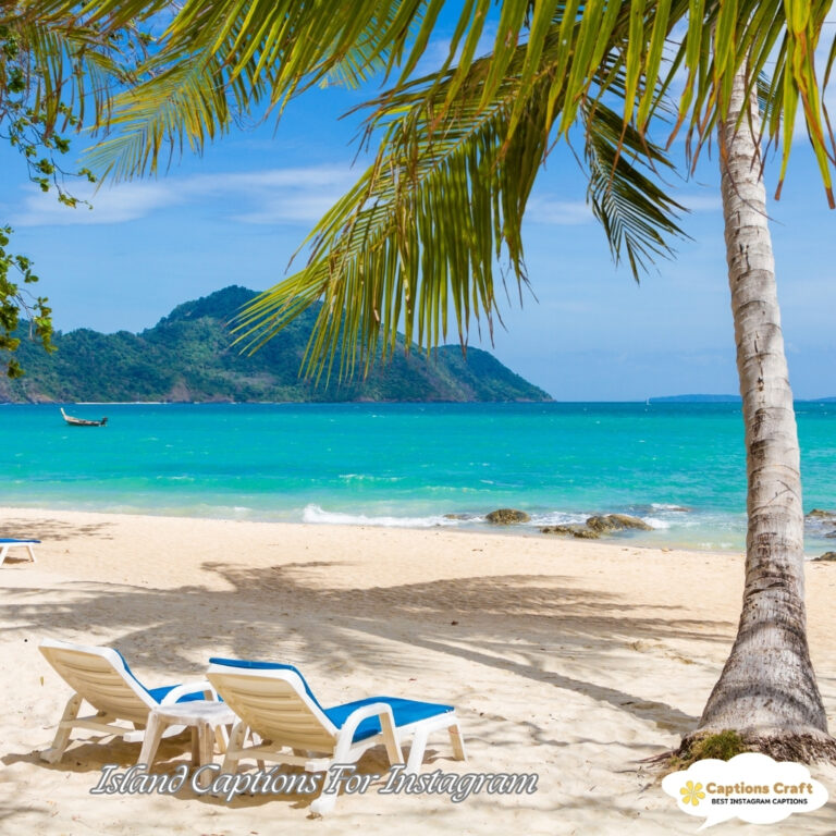 Pristine beach with clear blue water and lounge chairs under palm trees.