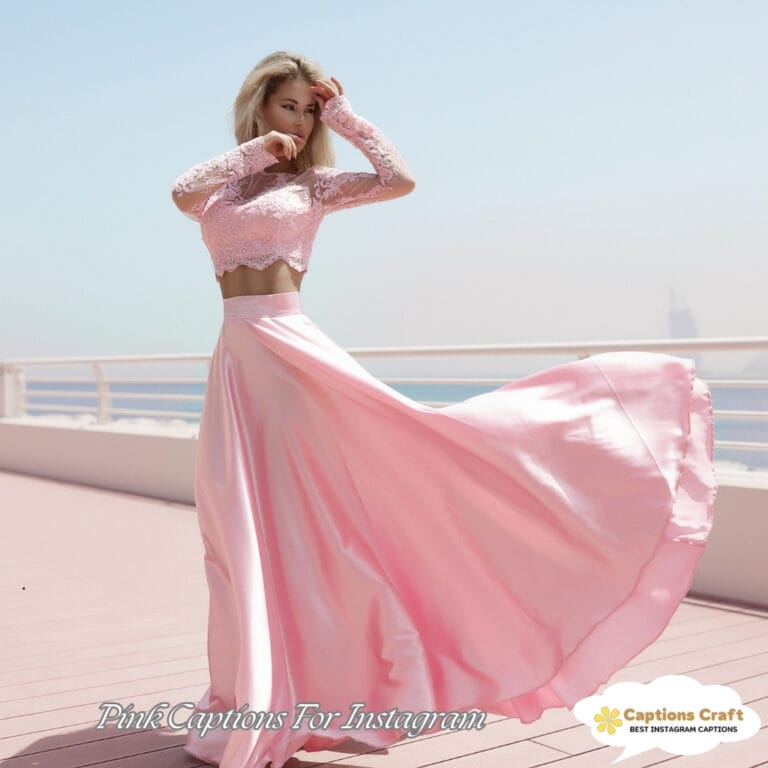 A woman twirls in a flowing pink skirt and lace top, hair dancing in the breeze.