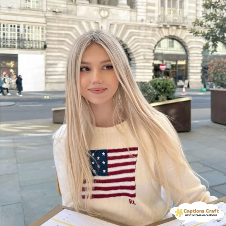 Young woman with long blonde hair wearing a sweater with an American flag design.