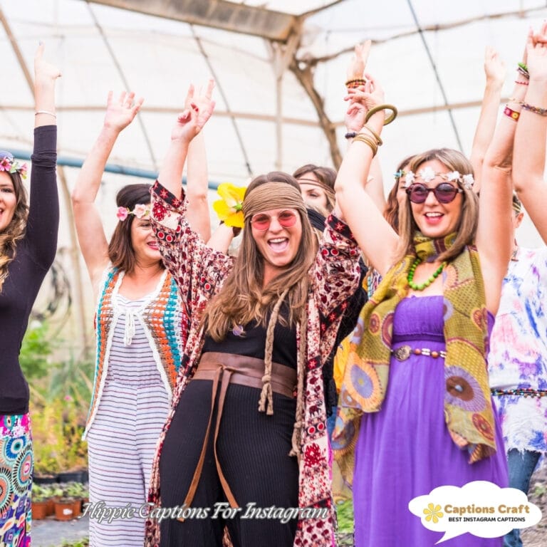 A group of joyful women celebrating, hands raised, wearing vibrant outfits, in a greenhouse.
