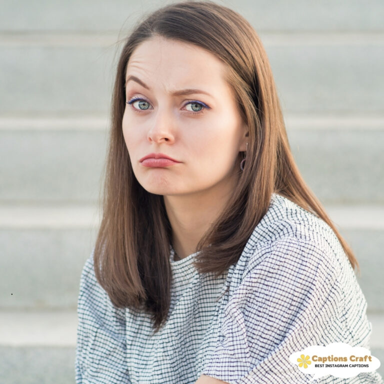 Woman with a pouting expression sitting on steps, looking displeased.