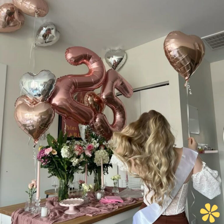 A woman turns away, showcasing long hair, a sash, and a festive setup with balloons and flowers.