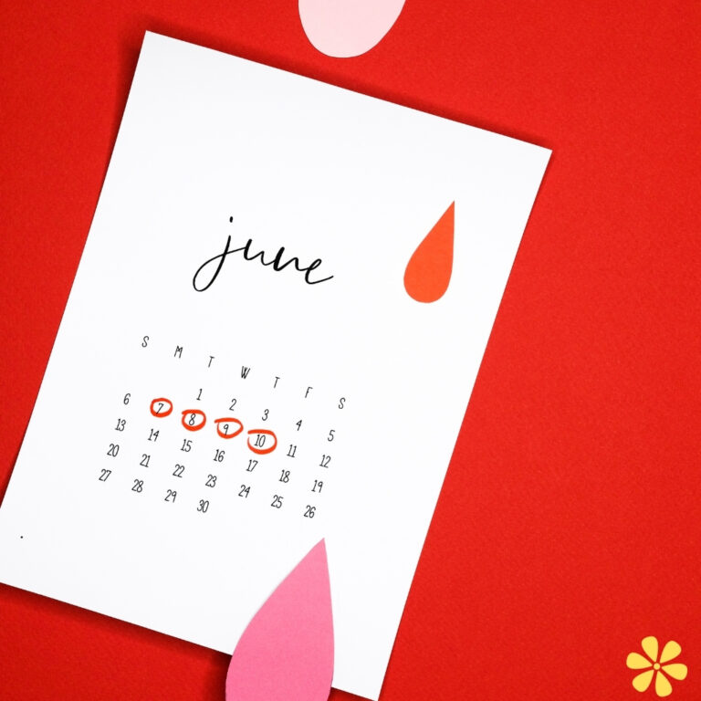 A calendar for June, with dates circled in red and colorful paper shapes around it.