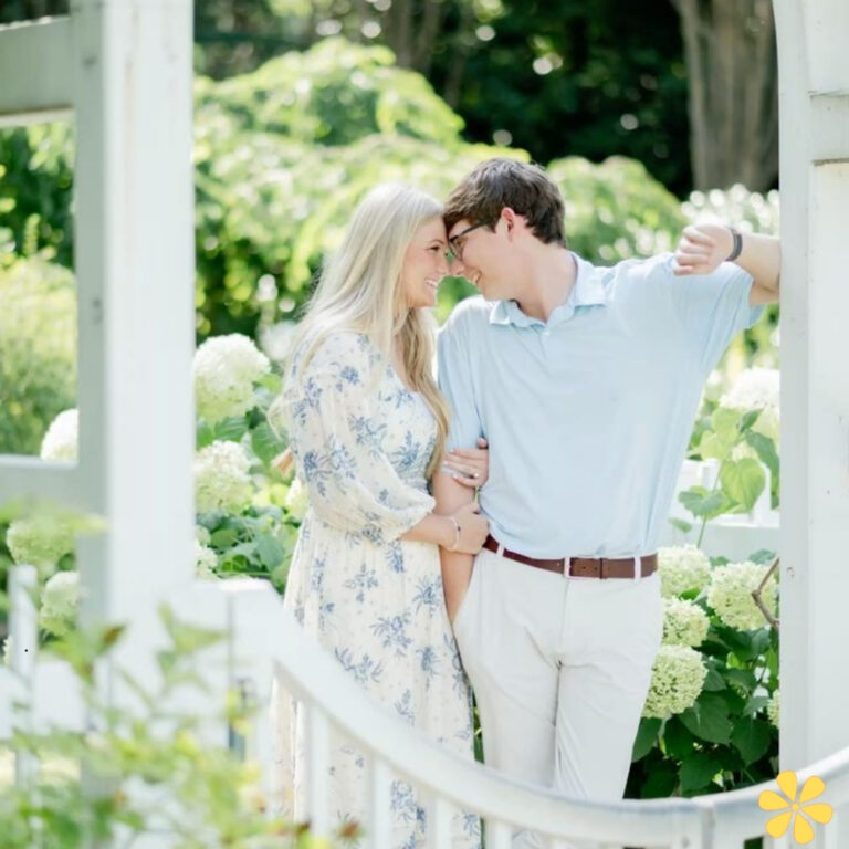A couple shares a tender moment, leaning in close amidst blooming hydrangeas.