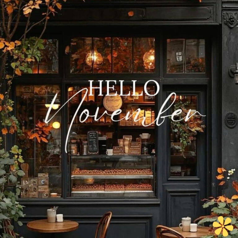 Charming café window adorned with autumn leaves and warm lights, displaying baked goods.