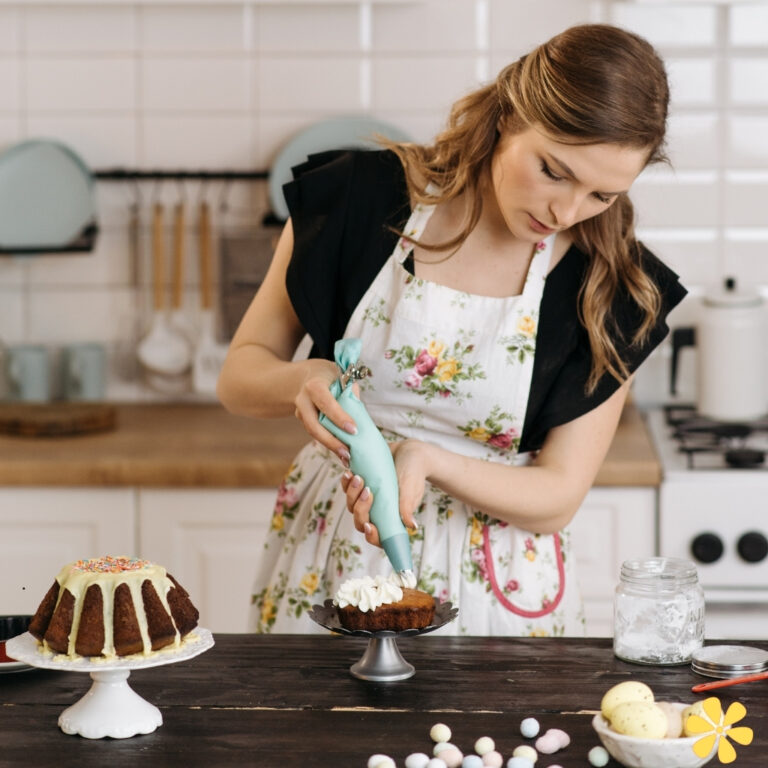 Baker decorating a cake with icing