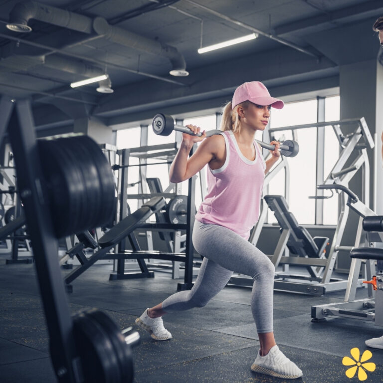 Woman exercising with a barbell in a gym setting