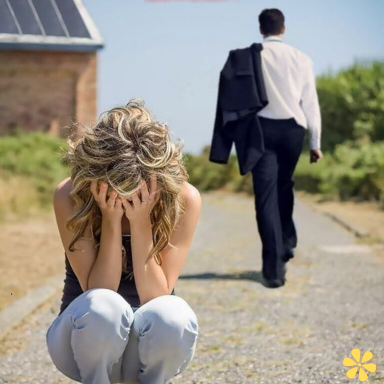 Woman sits in despair on a road as a man walks away.