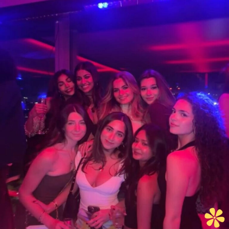 Group of women posing together at a vibrant party.