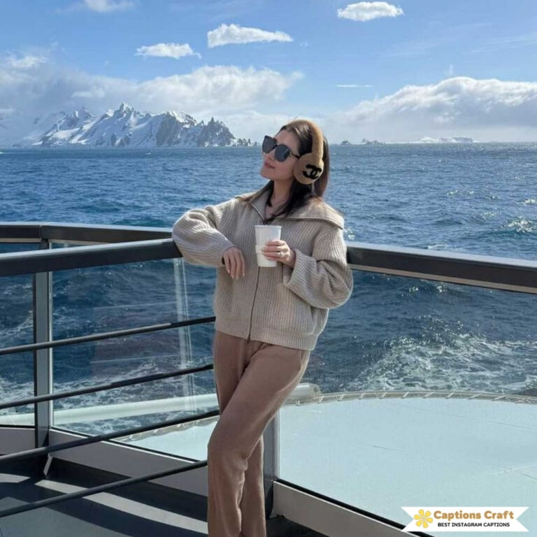 Woman enjoying a drink on a deck with mountains in the background.