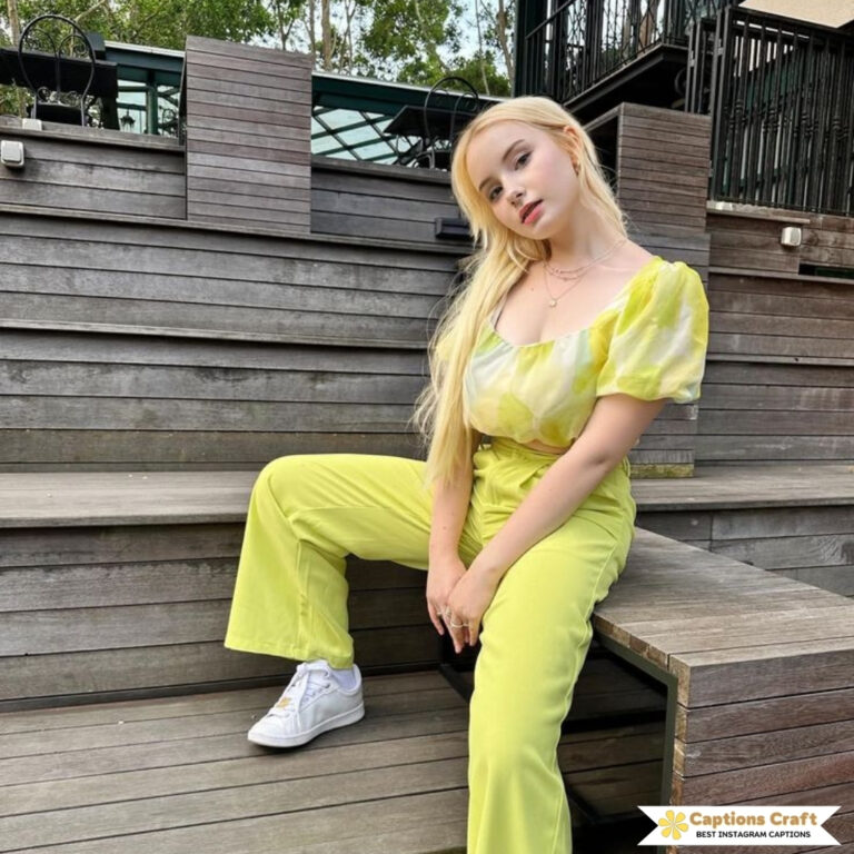 Blonde model in a bright yellow outfit sits casually on wooden steps.