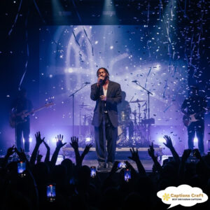 Singer performing on stage with confetti falling.