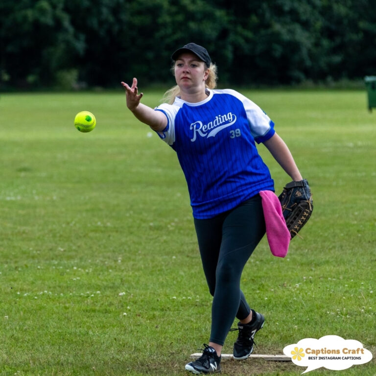 A player in a blue jersey prepares to throw a softball.