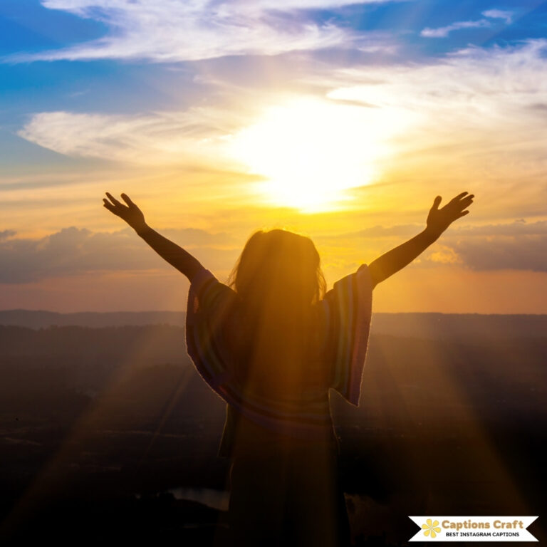 Silhouette of a girl with arms raised against a sunset sky.